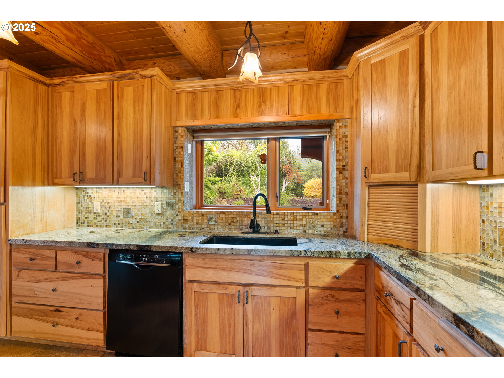 39582 Little Fall Creek Road Fall Creek, OR 97438 - Photo 10 of 44 a kitchen with granite countertop wooden cabinets and a large window
