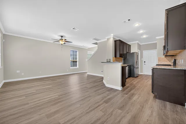 a kitchen with stainless steel appliances kitchen island a sink refrigerator and cabinets