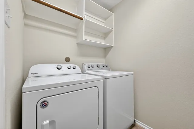 an empty room with ceiling fan and windows