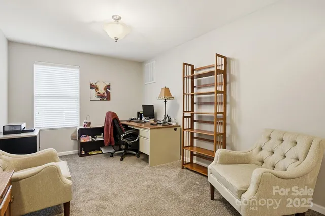 a view of a livingroom with workspace and a couch