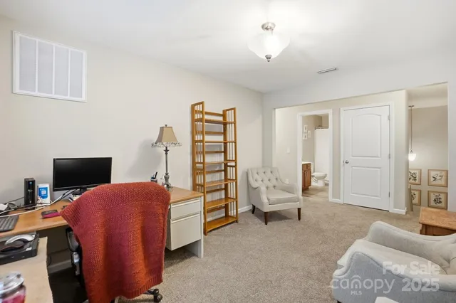 a bedroom with furniture and a chandelier
