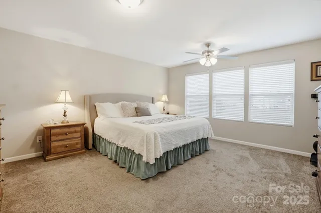 a spacious bedroom with a bed dresser and a window
