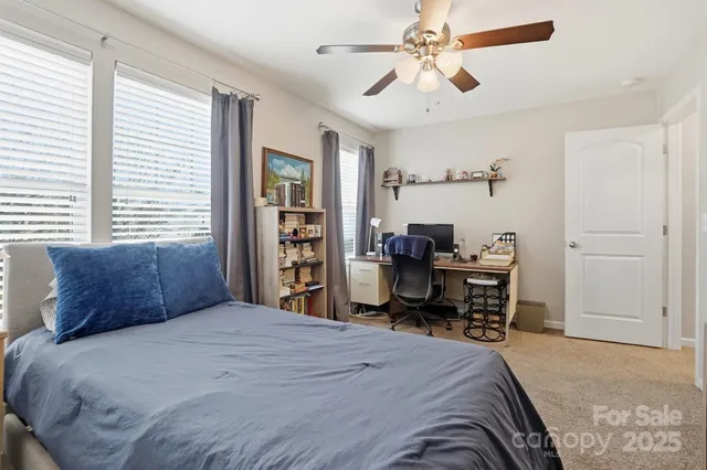 a bedroom with a bed and a desk