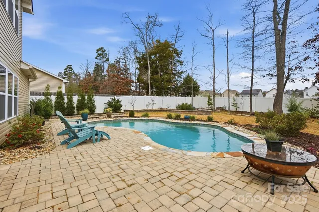 a view of a swimming pool with a lounge chairs