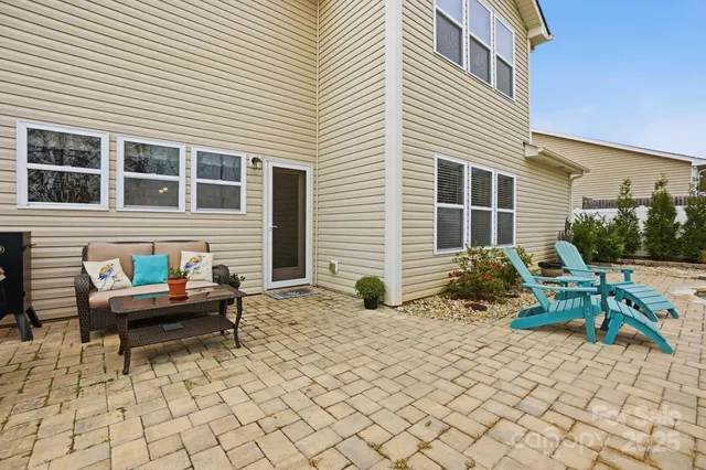 a backyard of a house with outdoor seating