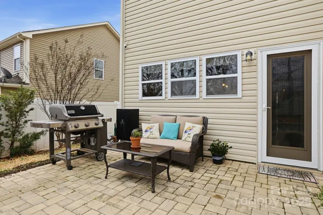 a backyard of a house with outdoor seating