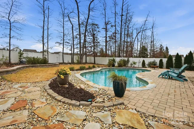 a view of a swimming pool with a lounge chairs