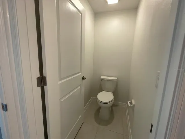 a bathroom with a granite countertop shower and a sink