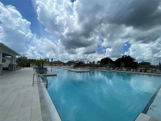 a view of a lake with houses in back
