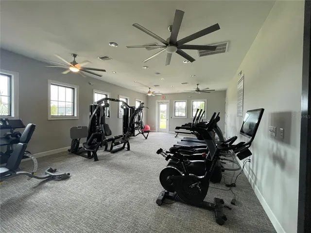 a view of a hallway with wooden floor and entryway