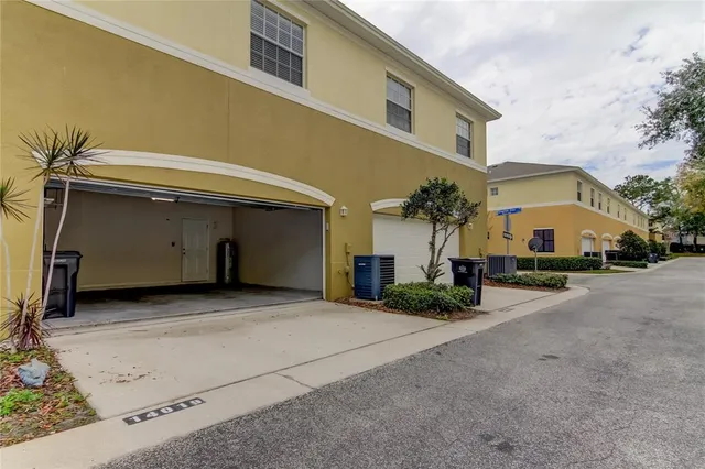 a front view of a house with garden and sitting area