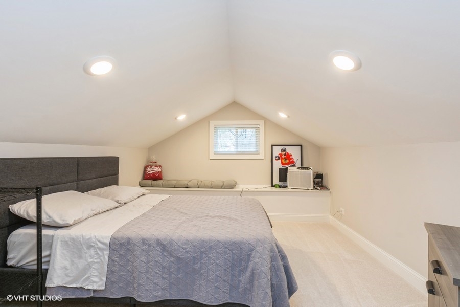 3205 Sprucewood Road Wilmette, IL 60091 - Photo 13 of 15 a spacious bedroom with a bed and a car with window
