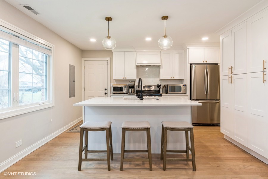3205 Sprucewood Road Wilmette, IL 60091 - Photo 2 of 15 a kitchen with kitchen island white cabinets and stainless steel appliances