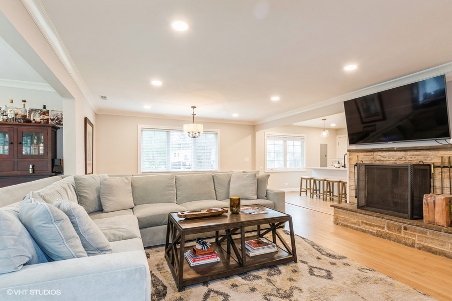 3205 Sprucewood Road Wilmette, IL 60091 - Photo 3 of 15 a living room with fireplace furniture and a flat screen tv