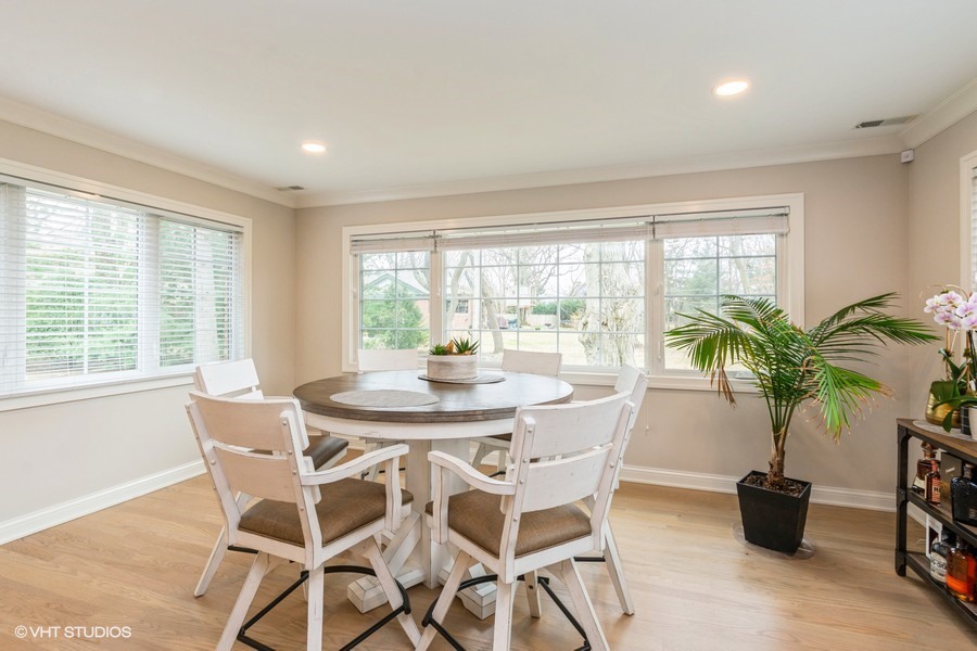 3205 Sprucewood Road Wilmette, IL 60091 - Photo 6 of 15 a view of a dining room with furniture and a potted plant