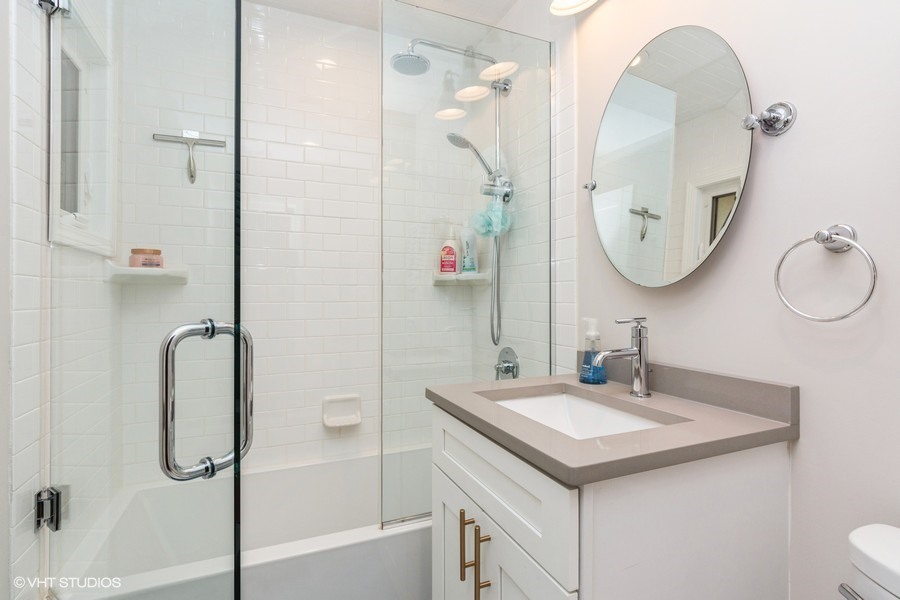 3205 Sprucewood Road Wilmette, IL 60091 - Photo 9 of 15 a bathroom with a sink vanity tub and a mirror