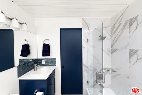 a bathroom with a toilet sink shower and mirror
