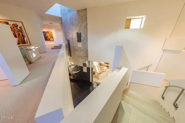 a view of a living room with furniture and floor to ceiling window