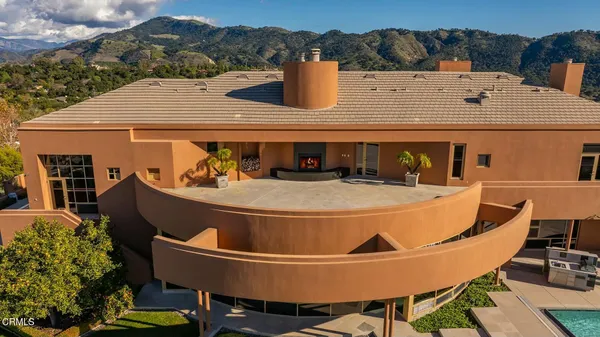 a view of a house with pool table and chairs