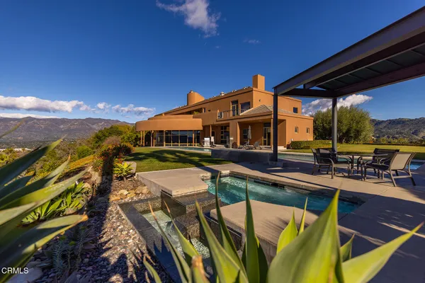 a view of a yard with a table and chairs