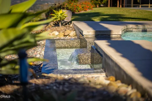 a view of an house with backyard space and parking