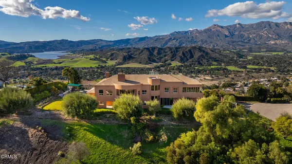 an aerial view of house a garden and mountain view in back