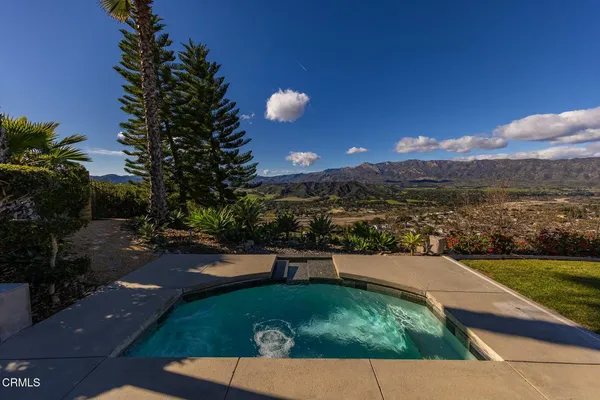 a view of a house with a yard and a swimming pool