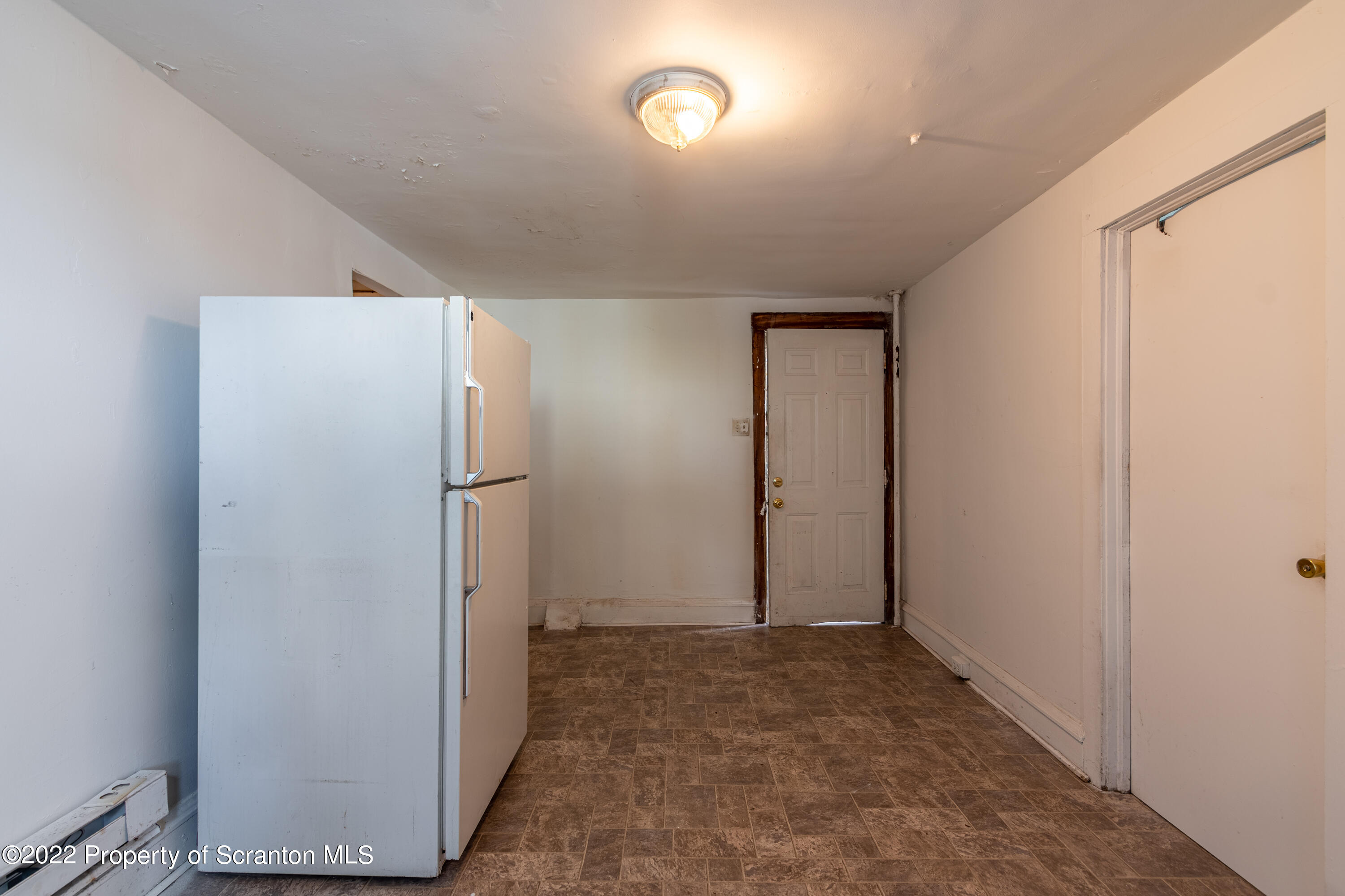 1509 Prospect Avenue Scranton, PA 18505 - Photo 20 of 28 a view of a refrigerator in kitchen and an empty room