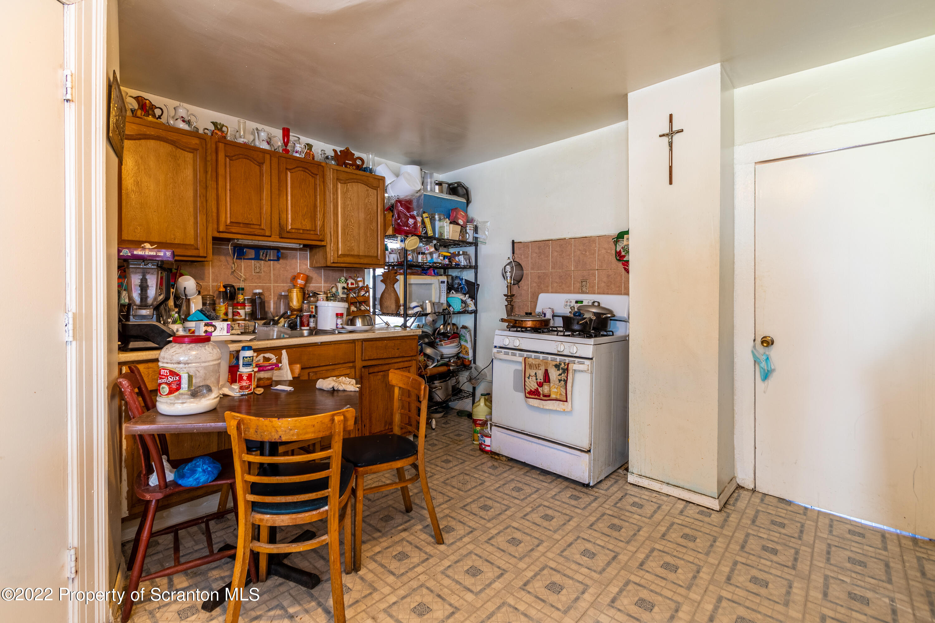 1509 Prospect Avenue Scranton, PA 18505 - Photo 24 of 28 a kitchen with stainless steel appliances a stove a chimney a refrigerator and cabinets