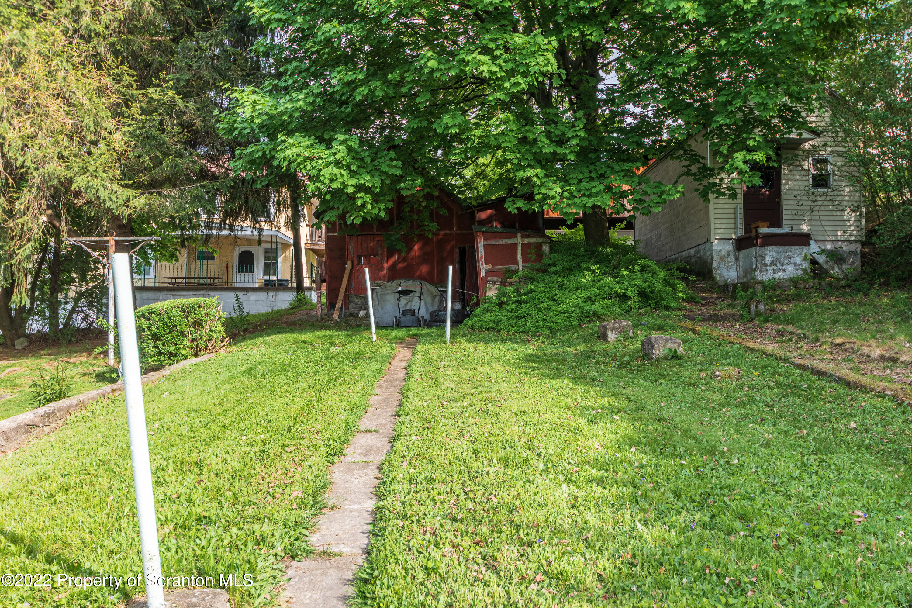 1509 Prospect Avenue Scranton, PA 18505 - Photo 3 of 28 a view of a backyard with table and chairs and a large tree