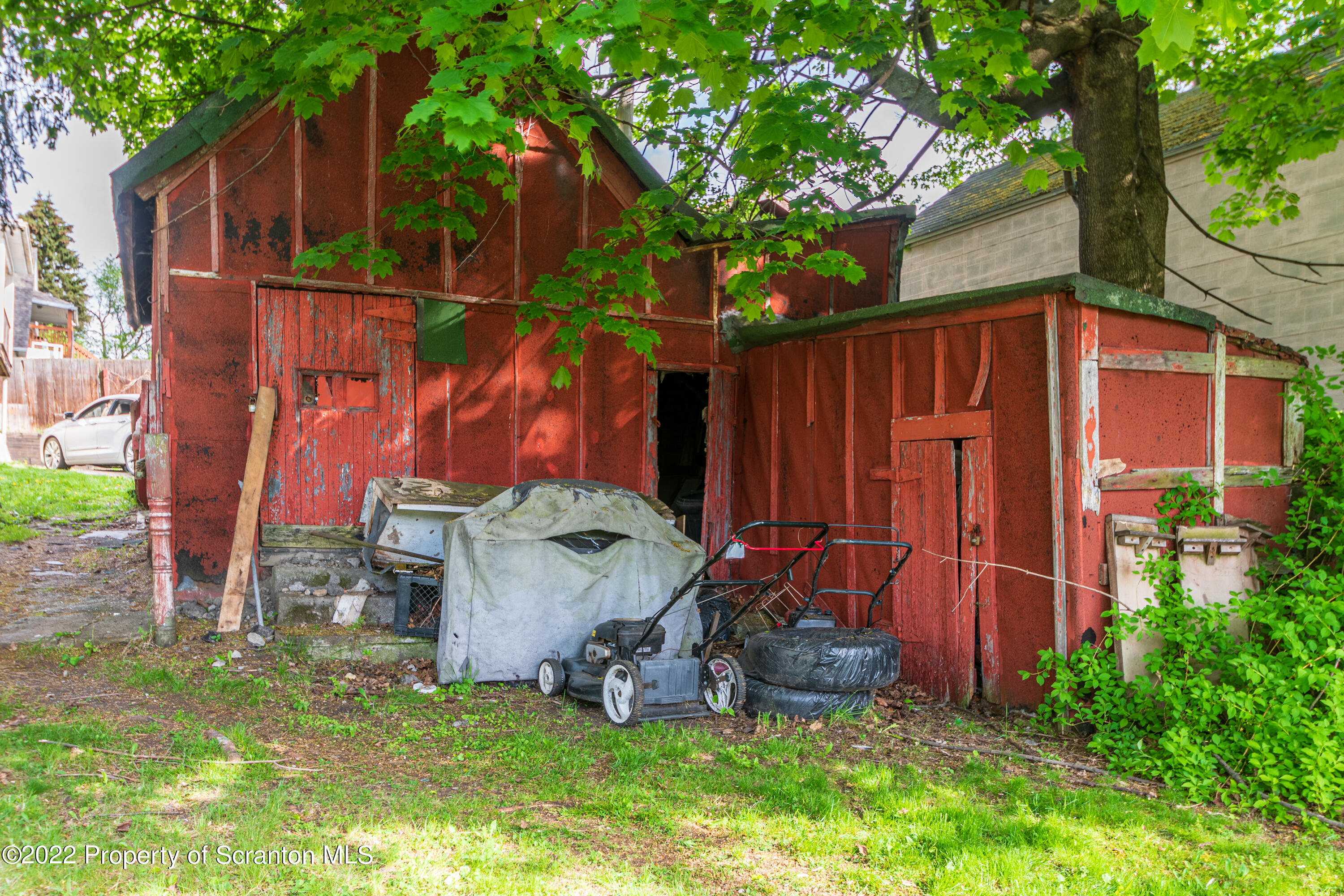 1509 Prospect Avenue Scranton, PA 18505 - Photo 5 of 28 a view of a backyard with potted plants and a large tree