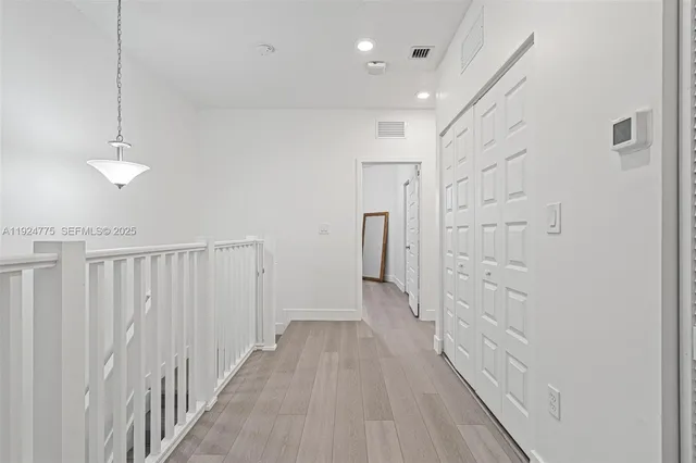 a view of a room with wooden floor table and chairs