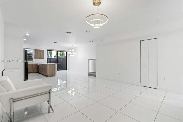 a kitchen with granite countertop a refrigerator and a sink