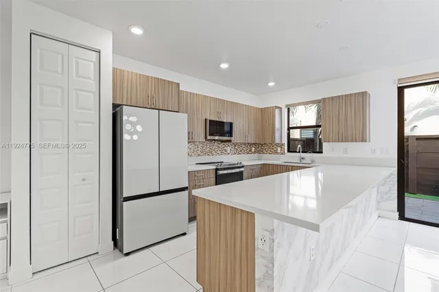 a kitchen with a sink stove top oven and cabinets