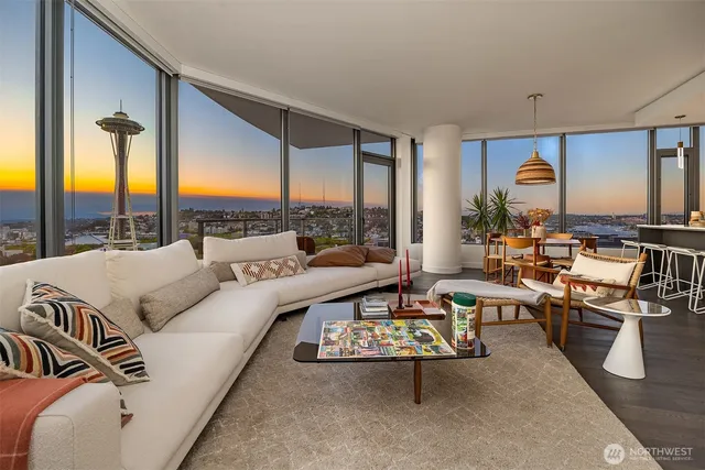 a living room with furniture and large windows