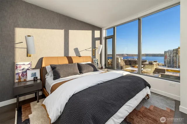 a bed room with a bed and a large window