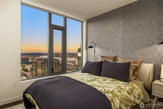 a bedroom with a large bed and a large window