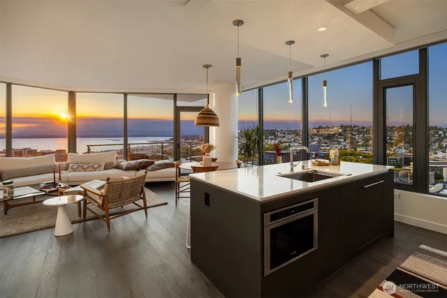 a kitchen with stainless steel appliances granite countertop a sink a stove and a refrigerator