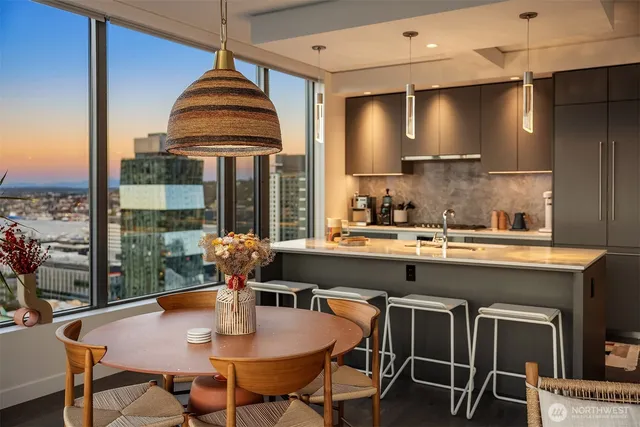 a kitchen with a table chairs stove and sink