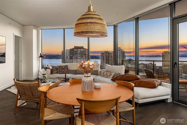 a dining room with furniture and a large window
