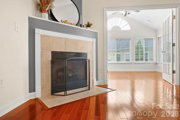 a living room with a fireplace and a floor to ceiling window