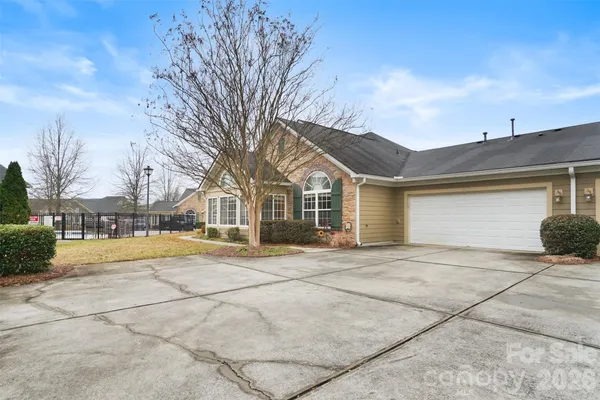 a view of a house with snow on the road