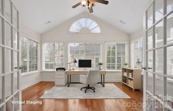 a work room with furniture and a large window