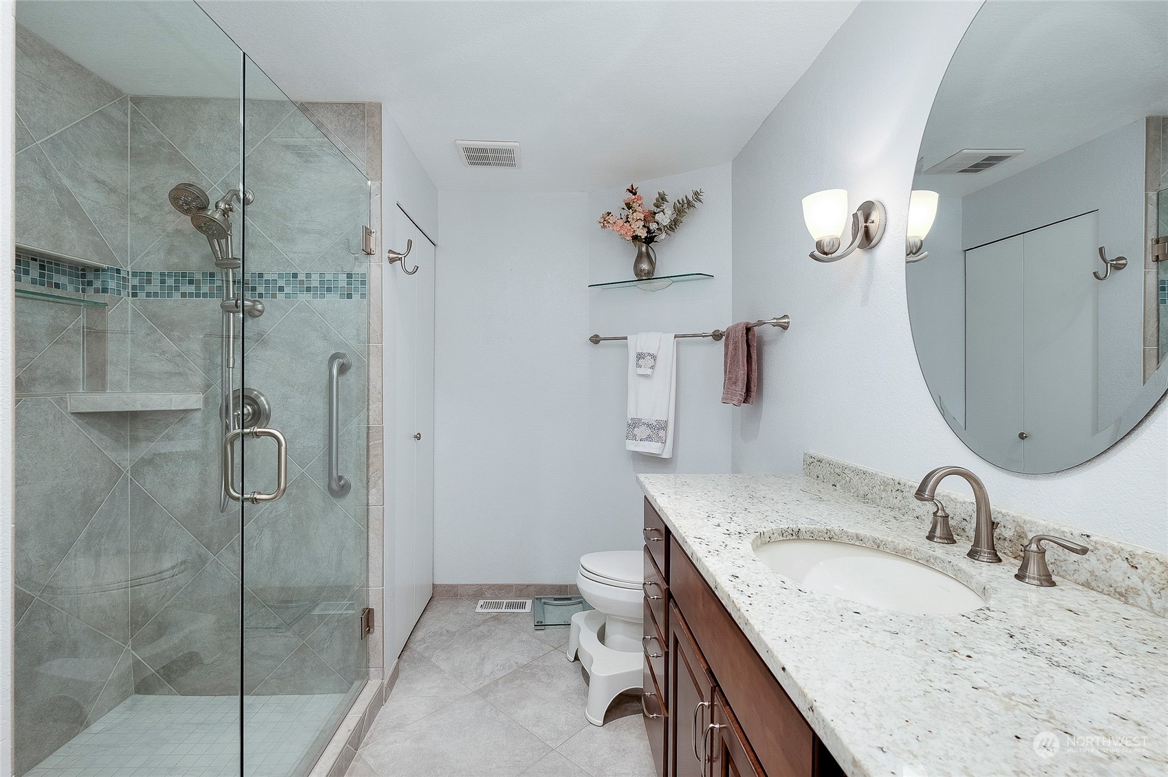 1135 Wheaton Way, Unit B3 Bremerton, WA 98310 - Photo 3 of 17 a bathroom with a granite countertop sink a toilet and a mirror