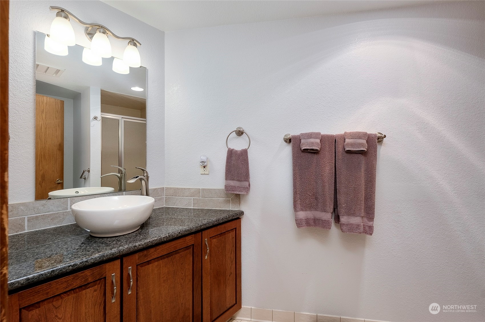 1135 Wheaton Way, Unit B3 Bremerton, WA 98310 - Photo 9 of 17 a bathroom with a granite countertop sink and a mirror