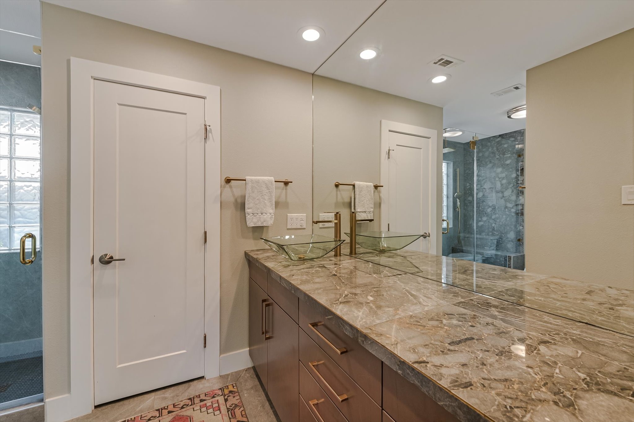 8121 Raintree Place Austin, TX 78759 - Photo 11 of 26 Marble vanity and and walk-in shower