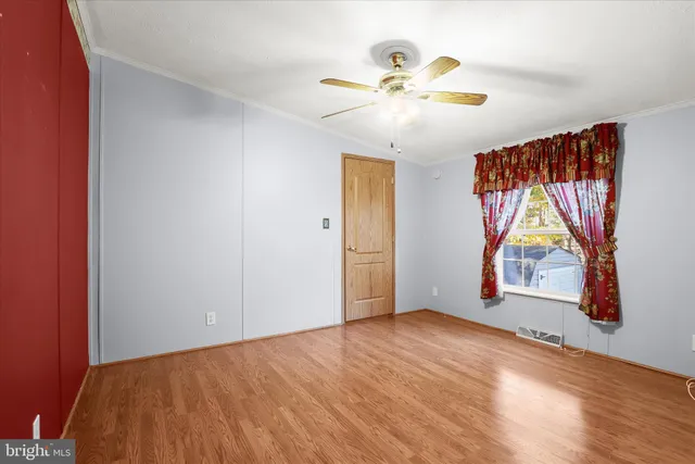 a view of an empty room window and wooden floor