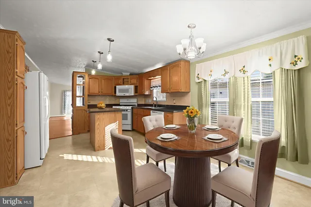 a view of a dining room with furniture and chandelier