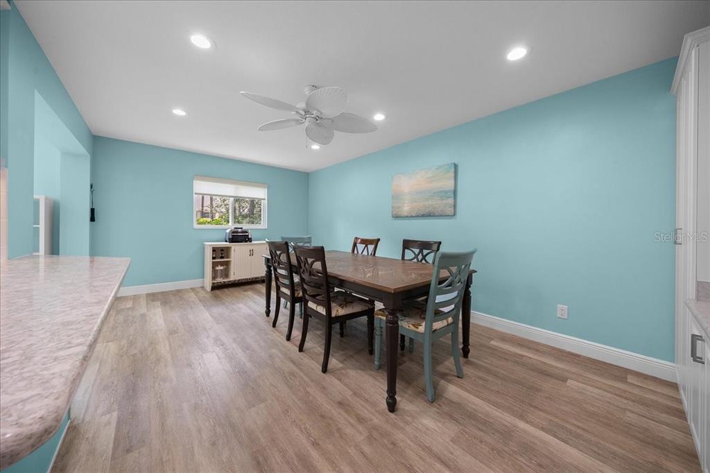 8720 Southwest 90th Street, Unit A Ocala, FL 34481 - Photo 25 of 71 a view of a dining room with furniture and wooden floor