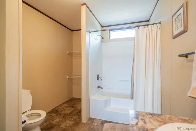 a bathroom with a shower and a toilet